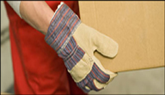 a box is being lifted by hands with canvas gloves on