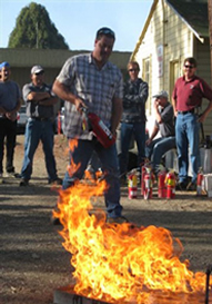 fire extinguisher training with a set fire and class participants