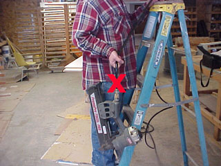 worker carrying a tool by the cord