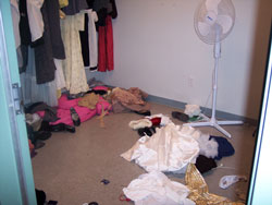 a dressing room with clothes and hangers all over the floor